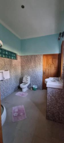 a bathroom with two sinks and two toilets in it at Kartika Villas in Lovina