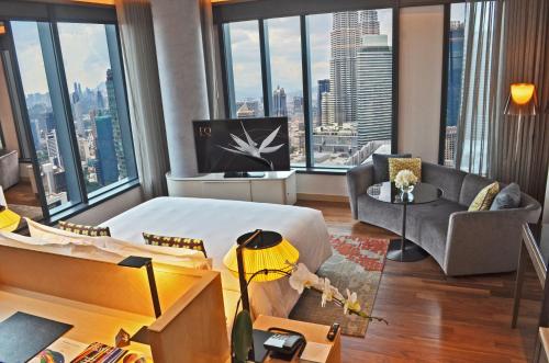 a living room with a view of a city at EQ Kuala Lumpur in Kuala Lumpur