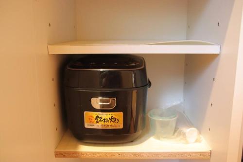 a toaster sitting on a shelf in a cabinet at Yamaguchi House Villa,Historic Japanese Room with Onsen in Miyanoshita