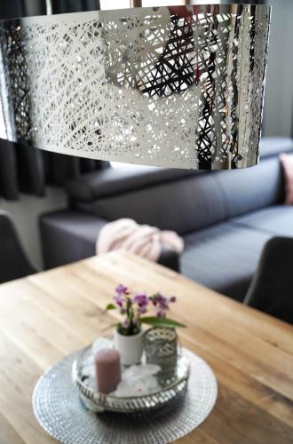 a table with a plate of food and flowers on it at Apartment Hänsel und Gretel in Dinkelsbühl