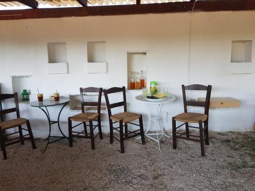 a group of chairs and a table in a room at Eco Glamping with Pool between Nafplio and Argos in Argos