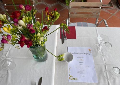 a table with a vase of flowers on it at Hotel Casa Valdese Roma in Rome