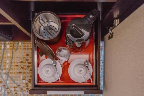 a group of dishes and a clock in a case at InterContinental Saigon, an IHG Hotel in Ho Chi Minh City