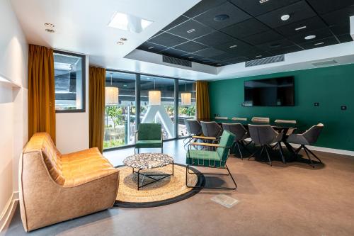 a conference room with a table and chairs at Best Western M-Treize Paris Asnieres in Asnières-sur-Seine