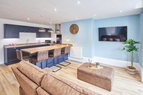 a living room with a couch and a kitchen at Host & Stay - Seaside Apartments in Saltburn-by-the-Sea