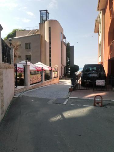 a car parked on a street next to a building at Prado Beach in Sunny Beach