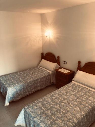 a hotel room with two beds in a room at Barqueiras15 in O Grove