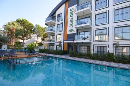 a swimming pool in front of a building at Juglans Suites in Fethiye