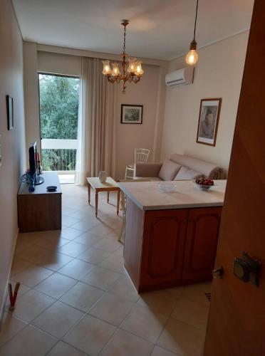 a kitchen and living room with a couch and a table at Jenny's luxury flat near the center & Beach in Kalamata