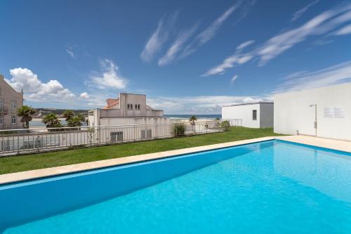 a swimming pool in the backyard of a house at Foz Beach House - Rooftop & Sea view in Foz do Arelho