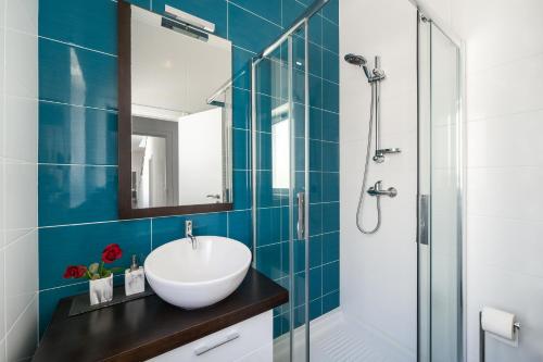 a bathroom with a sink and a glass shower at Foz Beach House - Rooftop & Sea view in Foz do Arelho