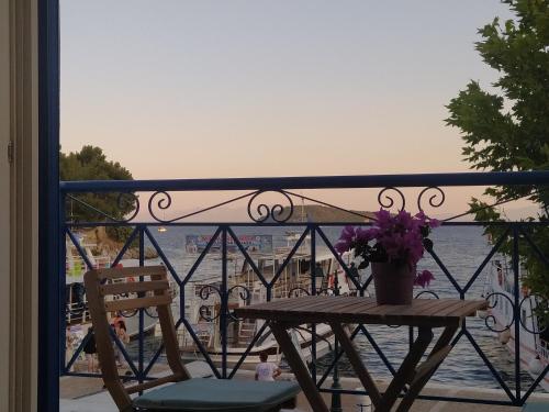 a table and chairs on a balcony with a view of the water at Emerald Blue in Skiathos Town