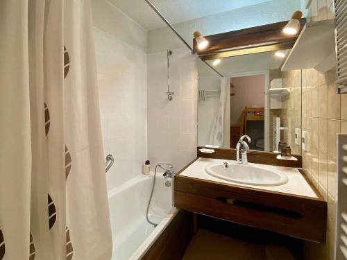 une salle de bain avec un lavabo, une baignoire et un miroir dans l'établissement Studio au cœur des Orres pour 4 pers avec balcon, proche commerces et activités - FR-1-322-430, aux Orres