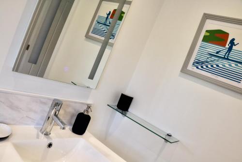 a bathroom with a sink and a mirror at Lawnside 1 in Budleigh Salterton