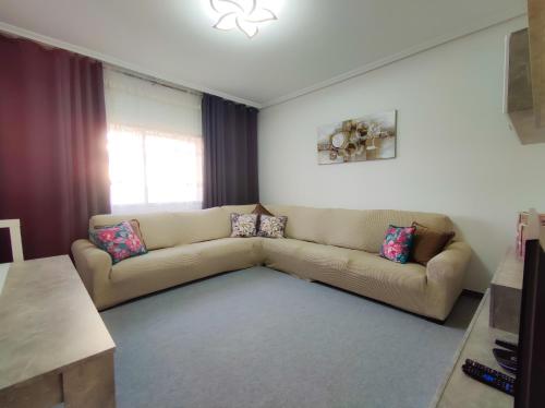 a living room with a couch and a window at Vivienda turística Mou in Arzúa