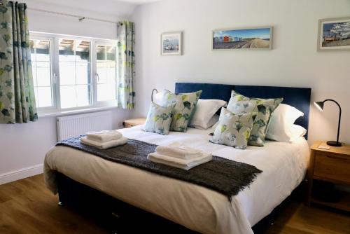 a bedroom with a bed with towels on it at Lawnside 3 in Budleigh Salterton