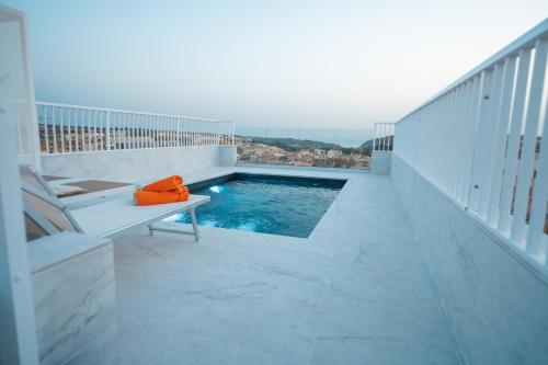 a swimming pool on the balcony of a building at Anici Crt Penthouse 4 - with private rooftop pool in Victoria
