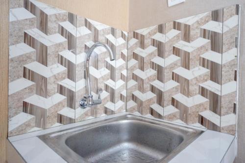 a bathroom with a sink with white blocks on the wall at RedDoorz Syariah near Stasiun Gumilir Cilacap in Gumilir