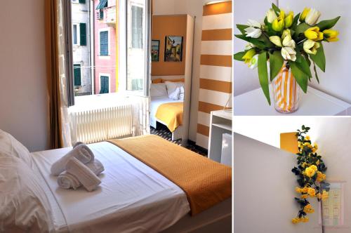 a hotel room with a bed and a vase of flowers at Giramondo in Rapallo