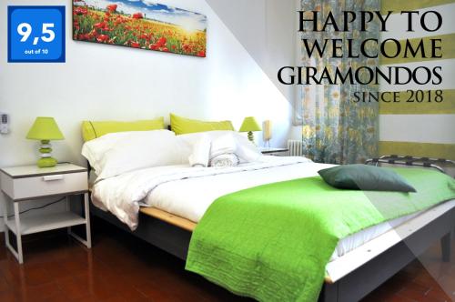 a bedroom with a bed with a sign that reads happy to welcomegomondos at Giramondo in Rapallo