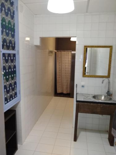 a bathroom with a sink and a shower with a mirror at Finca El Naranjo in Seville