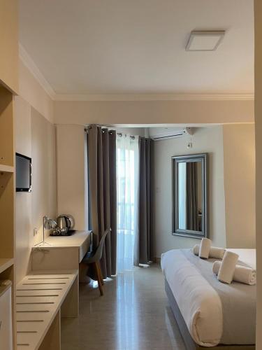 Un ou plusieurs lits dans un hébergement de l'établissement Bacoli Hotel