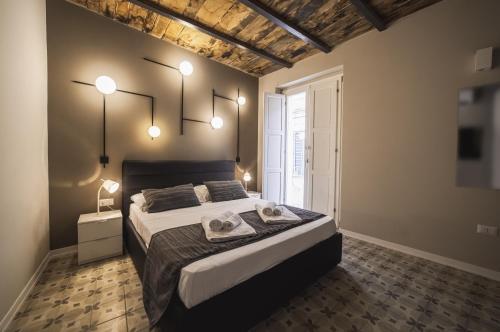 a bedroom with a large bed with two towels on it at Palazzo Paladini - Luxury Suites in the Heart of the Old Town in Pizzo