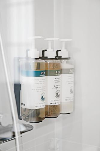 a group of four bottles of medicines on a shelf at Numa Madrid Script in Madrid