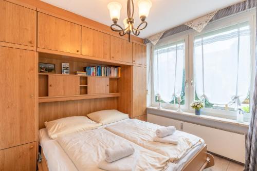 a bedroom with a bed and a window at Ferienhaus Grünten in Fischen