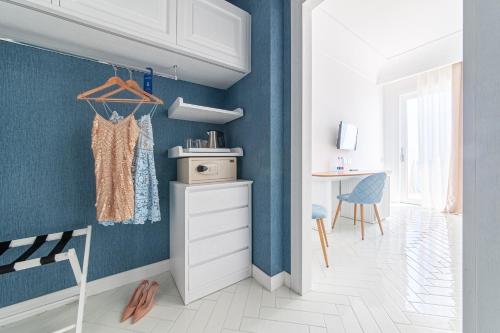 a living room with blue walls and a white floor at Hotel Club Due Torri in Maiori