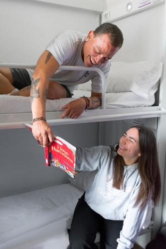 a man and a woman in a bunk bed at Kabul Party Hostel Barcelona in Barcelona