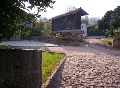a stone road with a building in the background at Stone Farm Hostel in Felgueiras