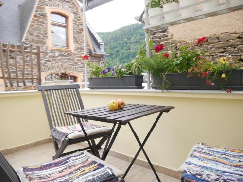 a table and a chair on a balcony at Ferienwohnung Munich in Traben-Trarbach