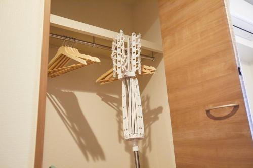 a walk in closet with a white chandelier at SG Premium KASAI in Tokyo