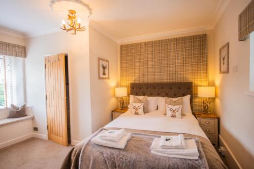 1 dormitorio con 1 cama con toallas en The George & Dragon Country Inn, en Seaton