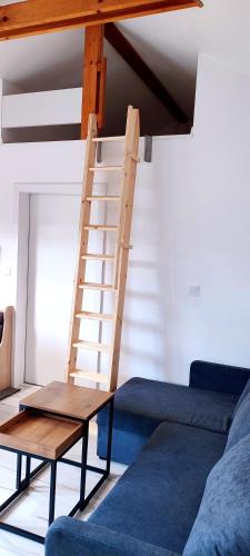 a wooden ladder in a living room with a couch at Aquamara Aquapark Tatralandia in Liptovský Mikuláš