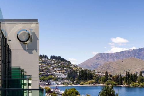 a view from a balcony of a city with mountains at QT Queenstown in Queenstown