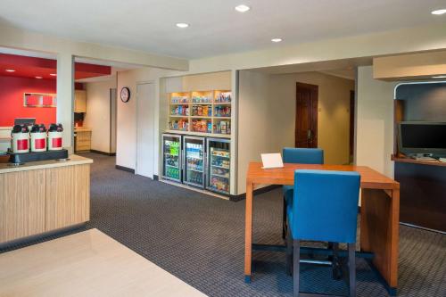 an office with a table and chairs and a refrigerator at Sonesta Simply Suites Seattle Renton in Renton