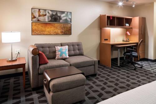 a hotel room with a couch and a desk at Sonesta Simply Suites Seattle Renton in Renton