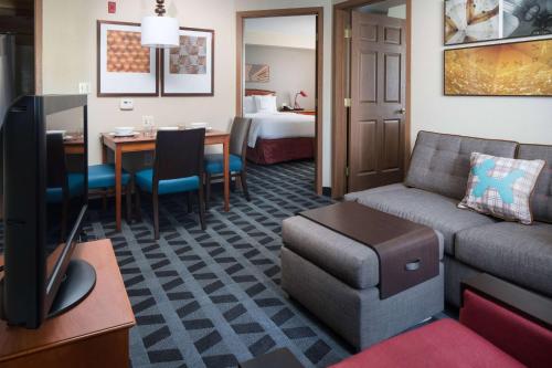 a living room with a couch and a room with a bed at Sonesta Simply Suites Seattle Renton in Renton