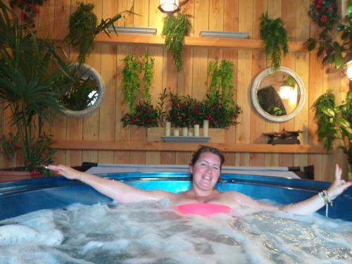 a man is in a jacuzzi in a hot tub at Chez Celine et Philippe appartement dans propriété de charme avec piscine in Le Fossat