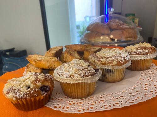 a bunch of muffins and other pastries on a table at Solmaris Tropea Rooms & Suites in Tropea