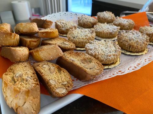 a tray of pastries and muffins on a table at Solmaris Tropea Rooms & Suites in Tropea