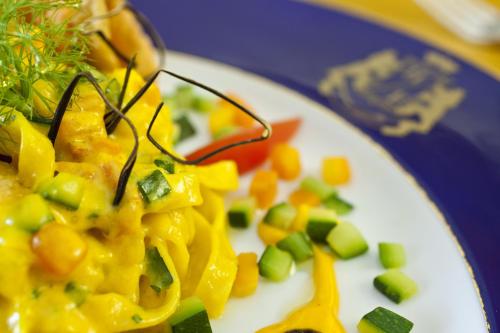 a plate of food with vegetables on a table at Excelsior Belvedere Hotel & Spa in Ischia
