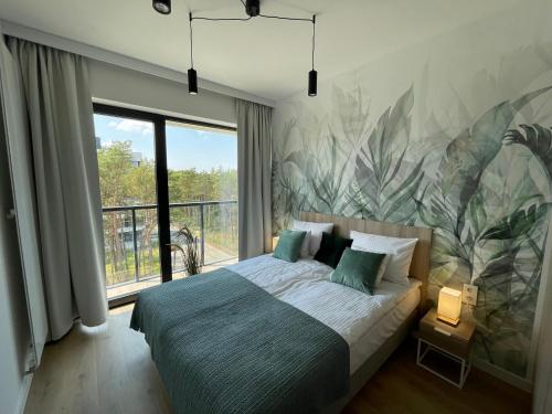 Una cama o camas en una habitación de Apartament z widokiem na morze Shellter Rogowo