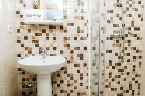 a bathroom with a sink and a shower at Hotel Medjugorje Irish Centre in Međugorje