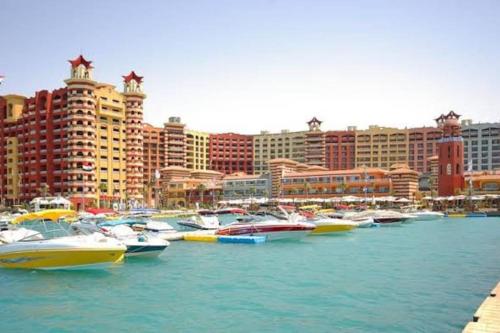 a group of boats parked in a harbor with buildings at فندق بورتو مارينا - غرفة فندقية بخدمة فندقية in El Alamein
