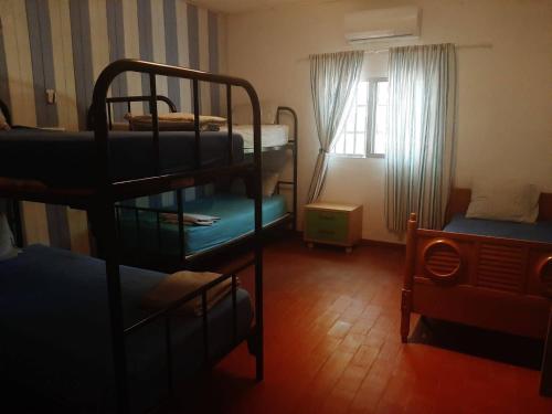 a bedroom with two bunk beds and a window at Finca El Naranjo in Seville