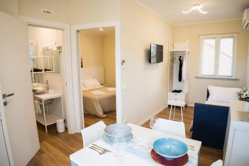 a small apartment with a table and a bedroom at Balconi Del Conero in Numana