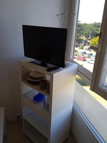 a tv on top of a white dresser with a window at Studio - Marina 6 - 35 allée des Pinons - 3-1 in Saint-Jean-de-Monts